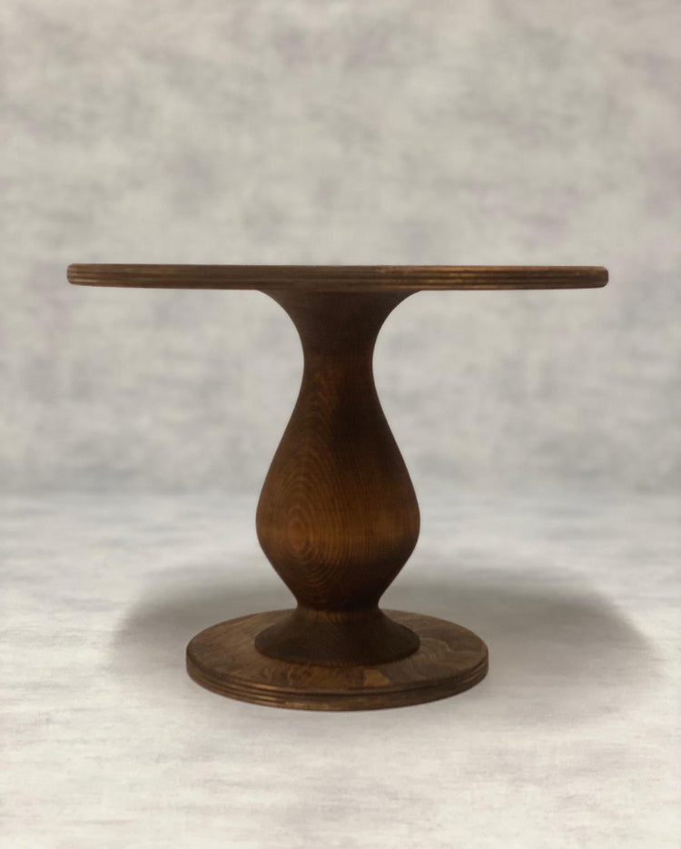 The Teardrop Scandinavian Birch Cake Stand tall size in a dark finish - Prop Options